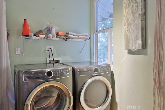 washroom with independent washer and dryer