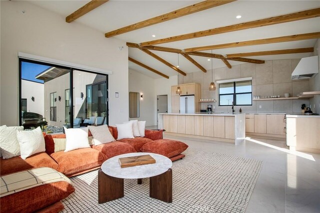 living room featuring beamed ceiling, sink, and high vaulted ceiling