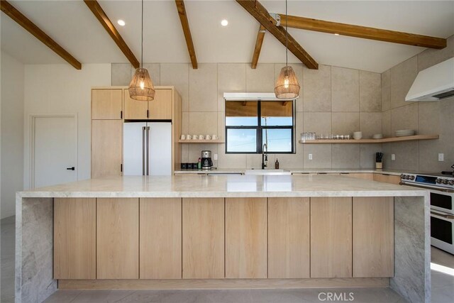 kitchen featuring double oven range, a center island, tasteful backsplash, light brown cabinetry, and high end refrigerator