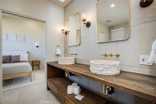 bathroom featuring vanity and tasteful backsplash