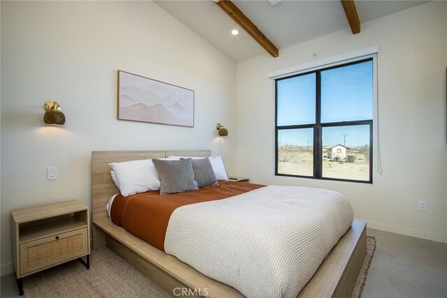 bedroom featuring vaulted ceiling with beams