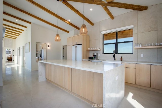 kitchen with light stone countertops, a center island, light brown cabinets, hanging light fixtures, and high end white refrigerator