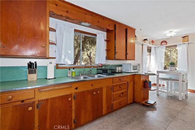 kitchen featuring plenty of natural light and sink