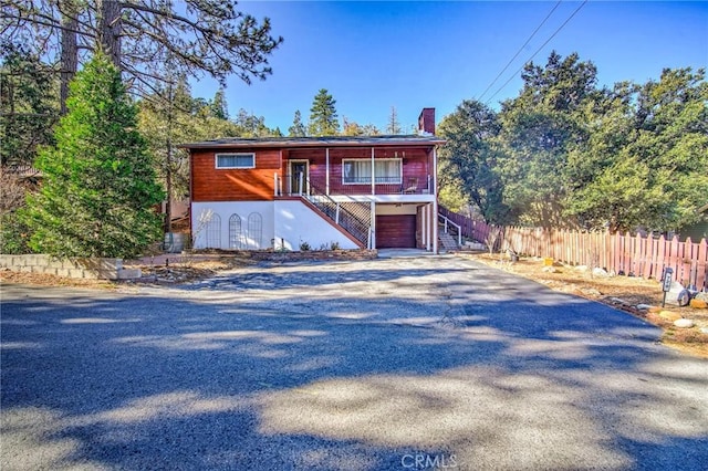 view of front of house with a porch and a garage