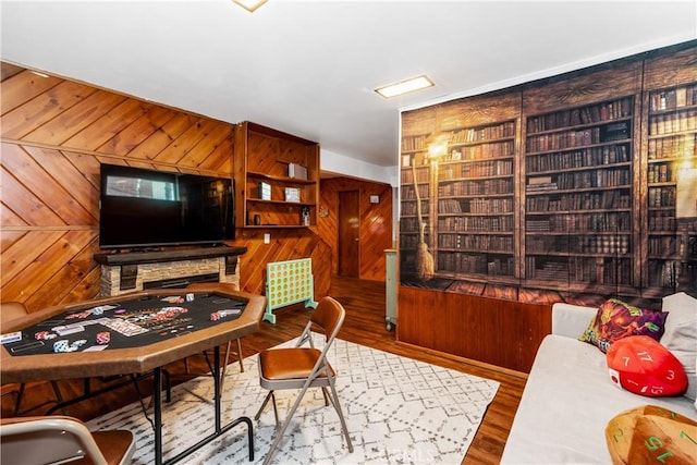 office area with hardwood / wood-style floors and wood walls