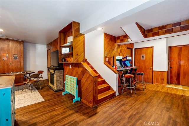 interior space featuring wooden walls and dark hardwood / wood-style floors