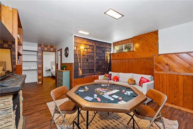 dining room featuring dark hardwood / wood-style floors and wood walls