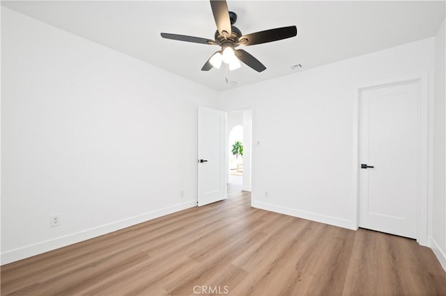 unfurnished room with ceiling fan and light wood-type flooring