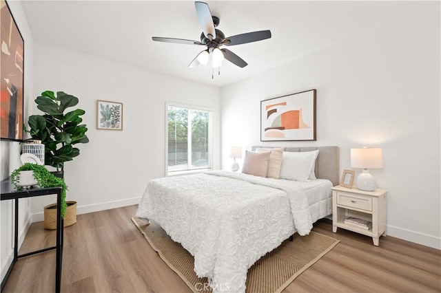 bedroom with light wood-type flooring and ceiling fan