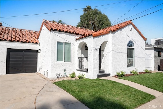 mediterranean / spanish-style house featuring a front lawn and a garage