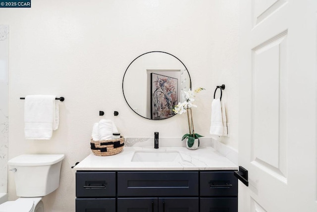 bathroom with toilet and vanity