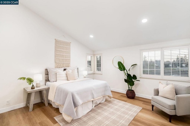 bedroom featuring light hardwood / wood-style flooring and lofted ceiling