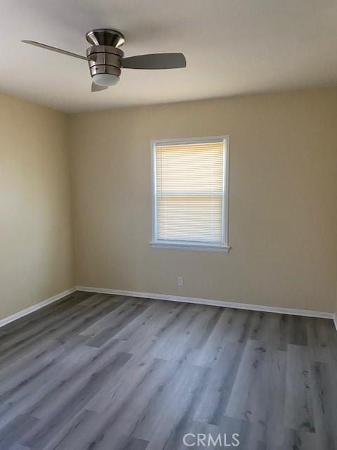 spare room featuring hardwood / wood-style flooring and ceiling fan