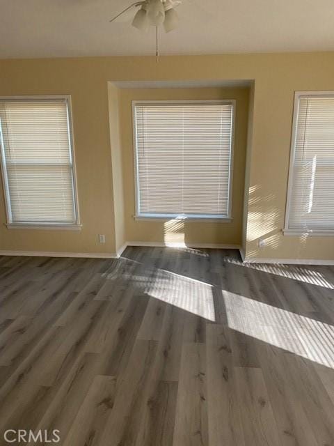 unfurnished room with ceiling fan and dark hardwood / wood-style floors