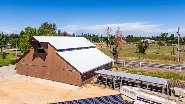 birds eye view of property with a rural view