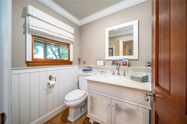 bathroom with hardwood / wood-style flooring, toilet, vanity, and ornamental molding