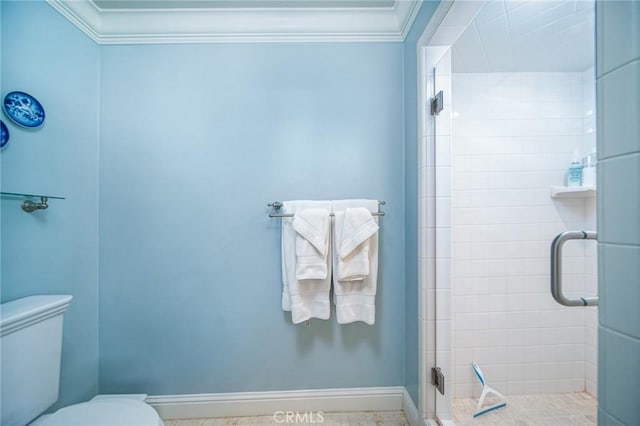 bathroom featuring toilet, an enclosed shower, and ornamental molding