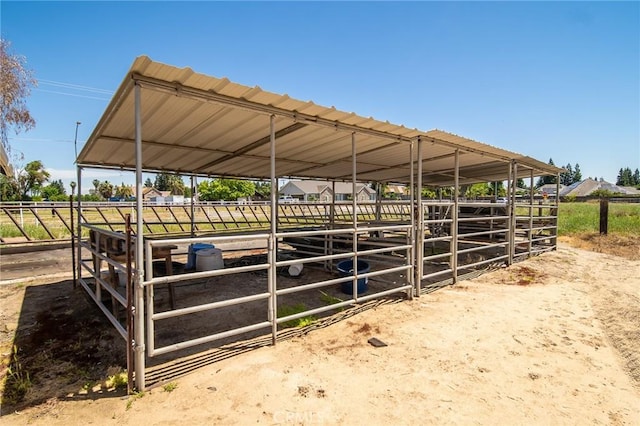 view of stable with a rural view