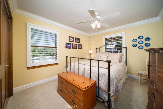 carpeted bedroom with ceiling fan, ornamental molding, and a closet