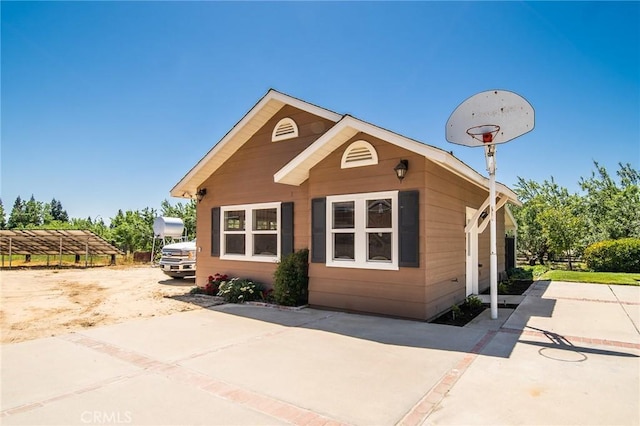 view of side of home featuring a patio area