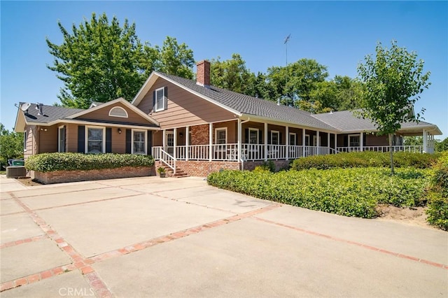 view of front of house with covered porch and cooling unit