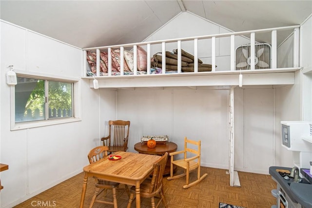 dining area featuring parquet floors and vaulted ceiling