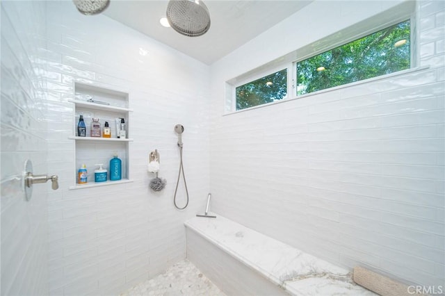 bathroom with tiled shower