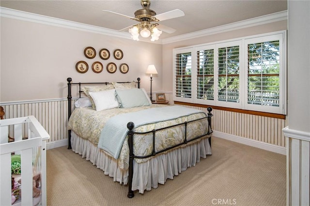 bedroom with ceiling fan, crown molding, and light carpet