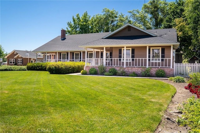 view of front facade with covered porch and a front yard