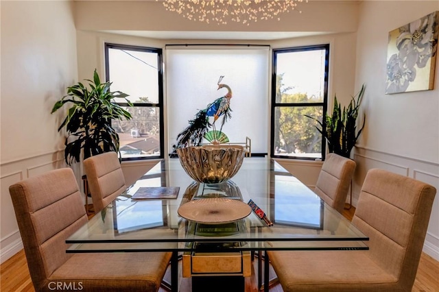 dining space with a chandelier and light hardwood / wood-style floors