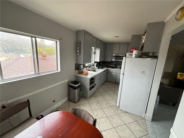 kitchen with gray cabinetry, crown molding, sink, decorative backsplash, and light tile patterned floors