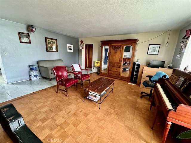 living room with a textured ceiling and light parquet floors