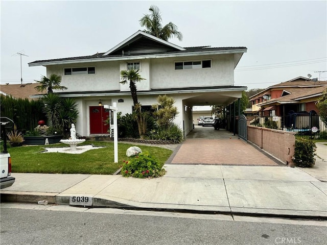 view of front of home with a carport and a front yard