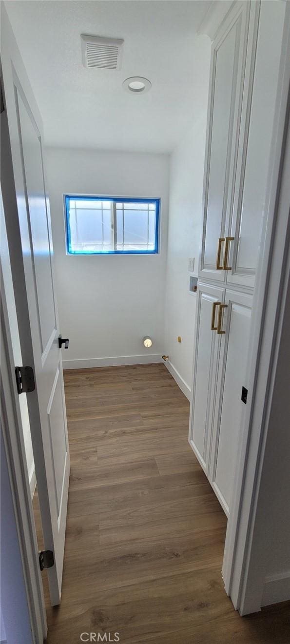 hallway with light hardwood / wood-style floors