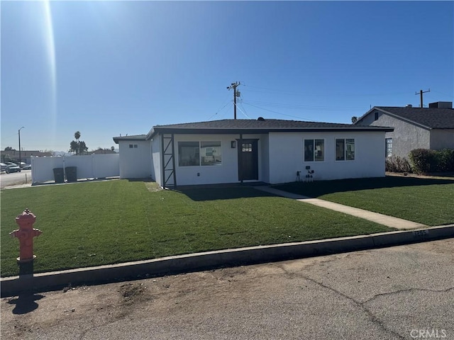 ranch-style house with a front lawn