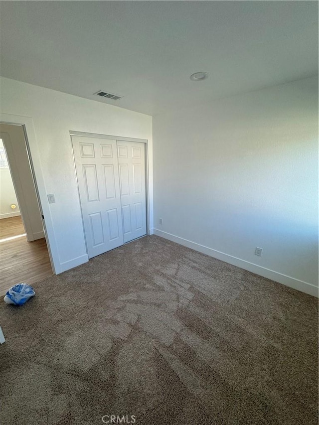 unfurnished bedroom featuring a closet and carpet floors