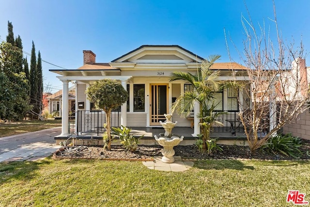 view of front of home featuring a front yard and a porch