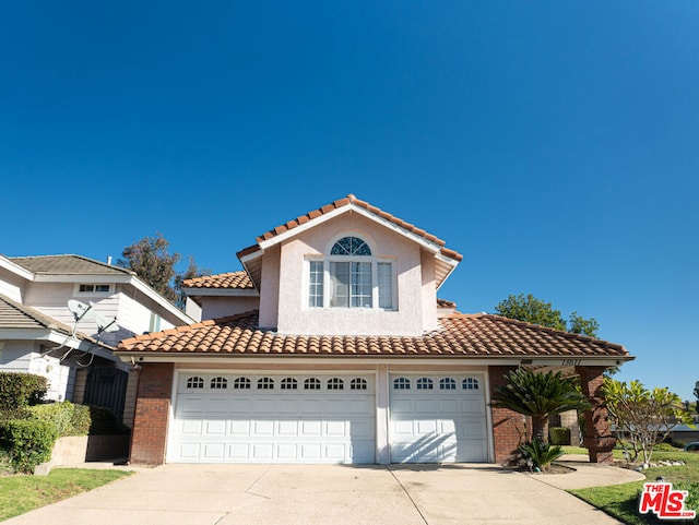 mediterranean / spanish house featuring a garage