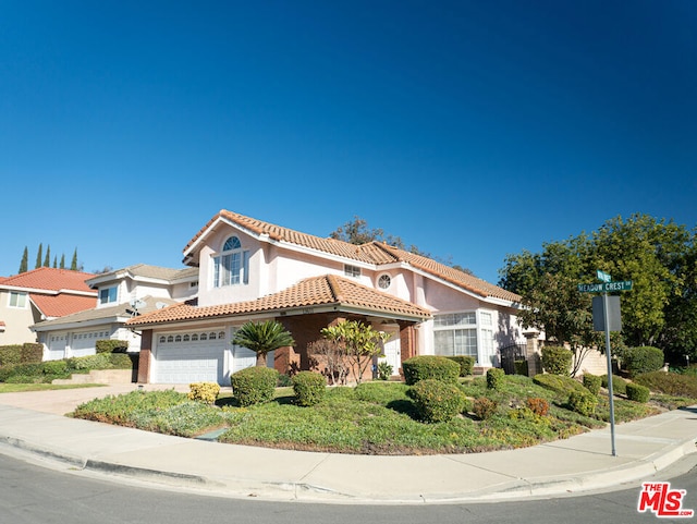 mediterranean / spanish-style house with a garage