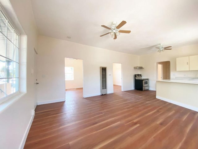 unfurnished living room featuring dark hardwood / wood-style floors and ceiling fan