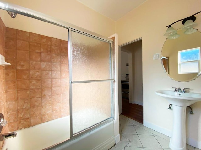 bathroom with tile patterned flooring, sink, and shower / bath combination with glass door