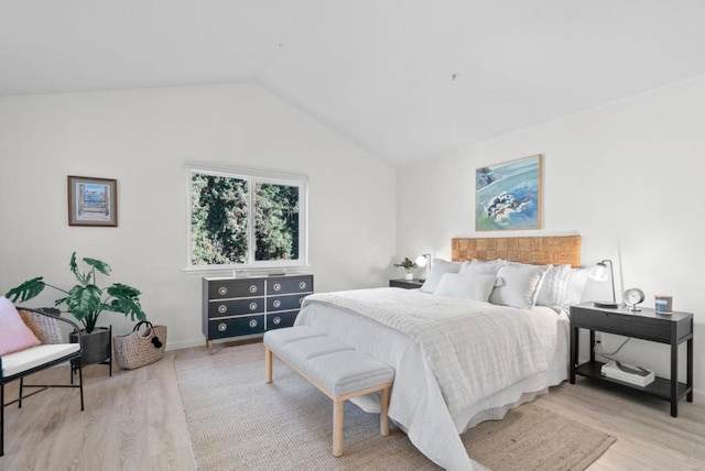 bedroom featuring vaulted ceiling and light hardwood / wood-style flooring