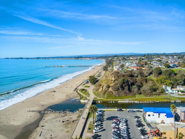 aerial view with a water view and a beach view