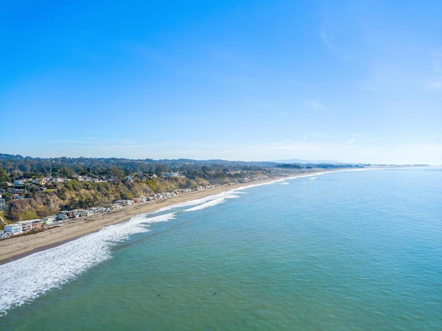 drone / aerial view featuring a water view and a beach view