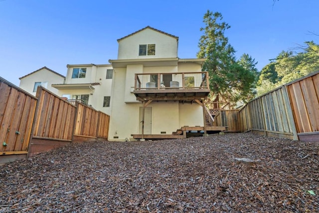 back of property with a balcony