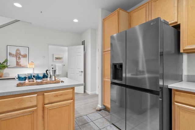 kitchen with light tile patterned flooring, light brown cabinetry, and stainless steel fridge with ice dispenser