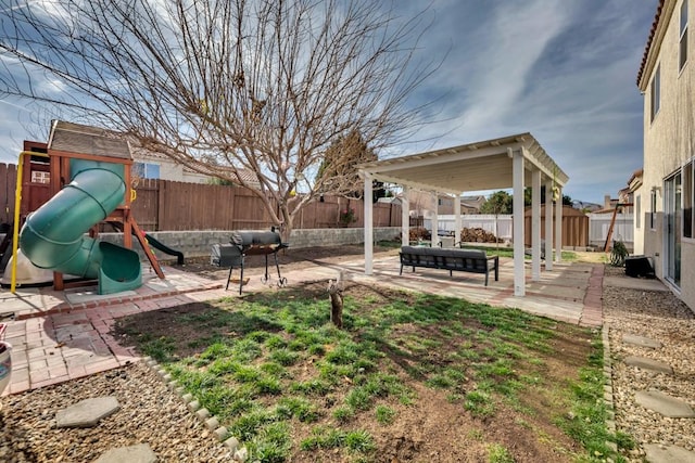 view of yard with a playground and a patio