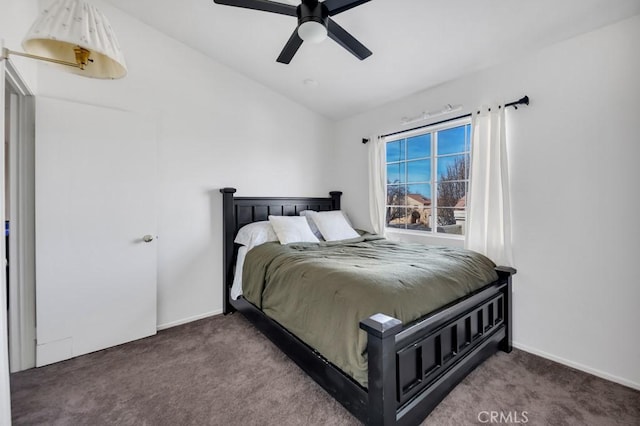 bedroom with ceiling fan, dark carpet, and lofted ceiling