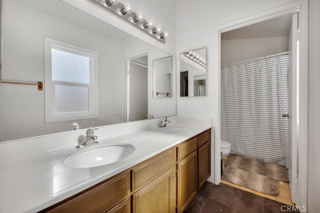 bathroom with vanity, toilet, and walk in shower