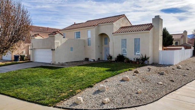 mediterranean / spanish house with a garage and a front lawn